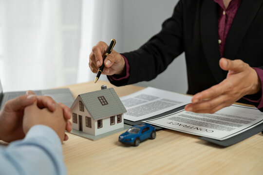 Dealers, Home And Auto Insurance Agents Are Introducing Homes To New Owners After Agreeing To A Home Sale Contract. Renting And Buying A Home Real Estate Agent Explaining To Client.