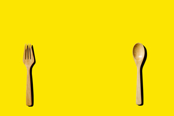 wooden spoon and fork, light and shadow Top view with space for your recipes.