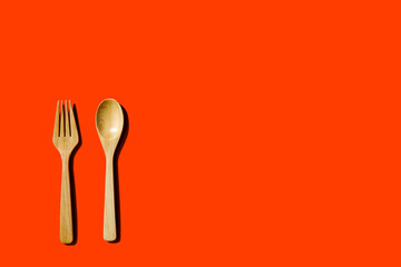 wooden spoon and fork, light and shadow Top view with space for your recipes.