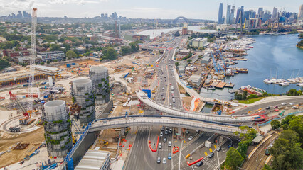 Aerial drone view of Rozelle Interchange showing major construction works and the large chimney towers with Anzac Bridge and Sydney City in the background in March 2023   - obrazy, fototapety, plakaty