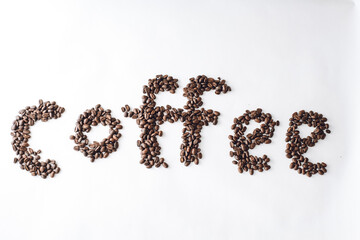 Coffee written in coffee beans on a white background