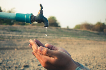 Hand for drinking water to live through drought, Concept drought and crisis environment. - 585299849