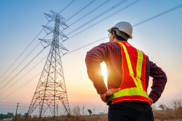 An Electrical engineers stand at a power station to see how to plan the production and export of...