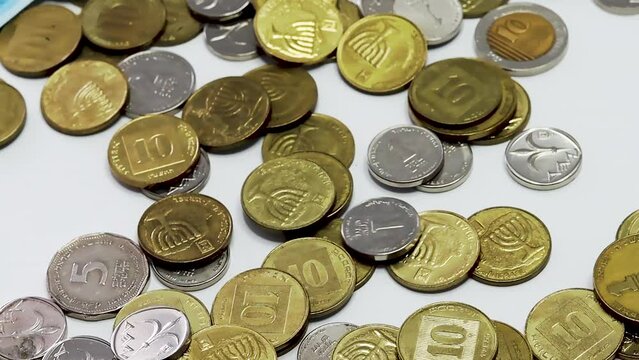 Israeli coins of the Bank of Israel. Israeli money is called Shekel, Sheqel, Shekels or Sheqalim. The slow motion video shows coins - 10, 5, 2 and 1 shekel, as well as smallest coins 50 and 10 agorot