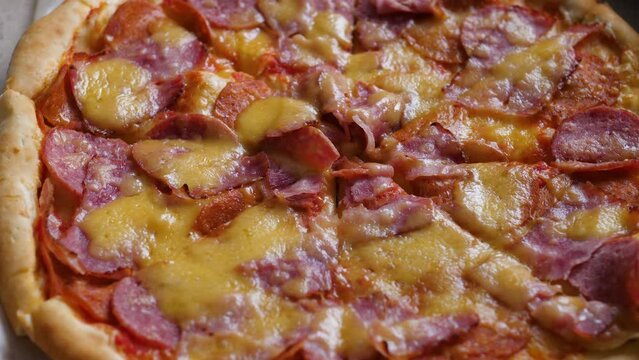 big paln open box with fresh appetizing pizza.selective focus. pizza delivery, fast food, italian food, pizza with bacon and salami