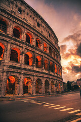Naklejka na ściany i meble Colosseum illuminated with lights in the evening in Rome, Italy