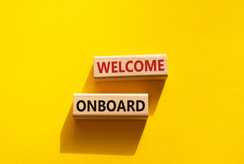 Welcome onboard symbol. Concept words Welcome onboard on wooden blocks. Beautiful yellow background. Business and Welcome onboard concept. Copy space.