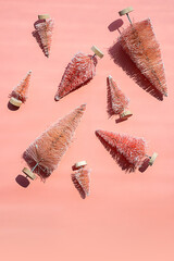 Miniature artificial Christmas trees, bottle brush trees for winter decor. Monochrome Christmas or New Year layout.