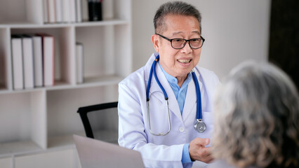 Male doctor writing prescription on clipboard while explaining m