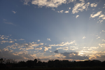 Fototapeta premium Beautiful sky and cloud at high. Landscape include space, light of nature, sunset, sunrise, horizon or skyline. Colorful with yellow, orange and blue at evening in autumn for background and wallpaper.