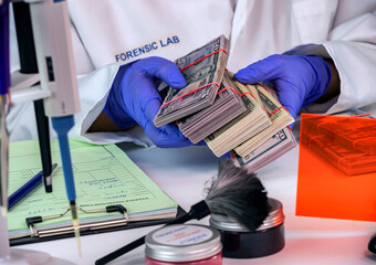 Police scientist examines dollar stolen from crime lab heist, conceptual image