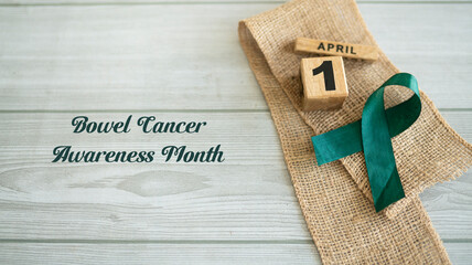 Bowel Cancer Awareness Month, A green ribbon on a mat Selective focus