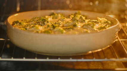 Baking fish with broccoli under cheese in the oven