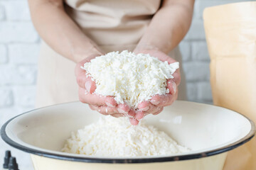 Woman making decorative aroma candles from soy wax