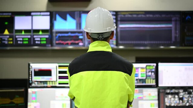 Engineer working at control room,Manager control system,Technician man monitoring program from a lot of monitor