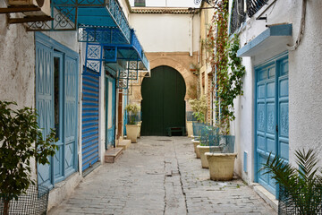 Fototapeta na wymiar Tunis Medina Alley with Blue Doors and Keyhole Door