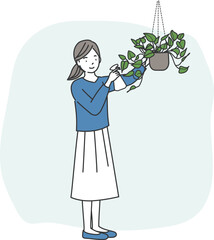 観葉植物の手入れをする女性