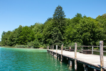 Wooden pier edging into the magnificent turquoise waters of Lake Kozjak in Plitvice Lakes National Park in Croatia