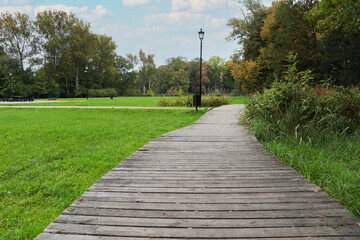 Beautiful public city park with pathway and green grass