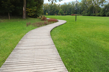 Beautiful public city park with pathway and green grass