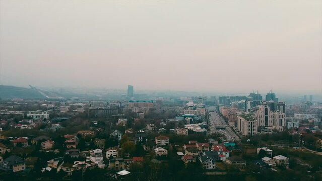 panoramic view of the city in the smog, motion view from left to right, Almaty