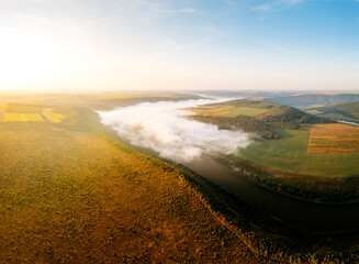 Impressive bird's eye view of the misty valley of the Dniester river. Ukraine, Europe.