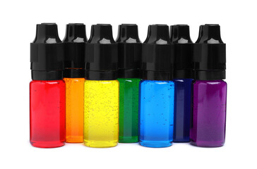 Bottles with different food coloring on white background