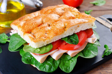 Focaccia Sandwich with Ham, Tomatoes, and Spinach, Sandwich with Italian Flat Bread on Wooden Background