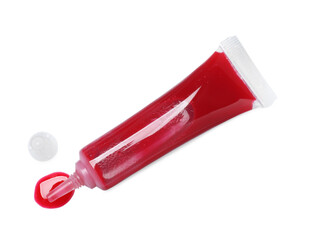Tube with red food coloring isolated on white, top view