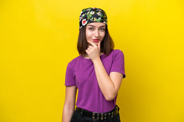 Young Ukrainian woman isolated on yellow background thinking