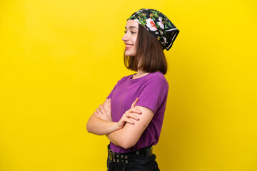 Young Ukrainian woman isolated on yellow background in lateral position