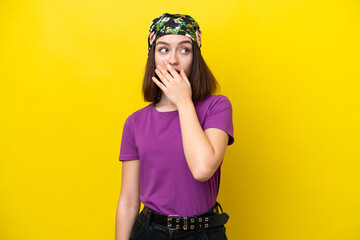 Young Ukrainian woman isolated on yellow background doing surprise gesture while looking to the side