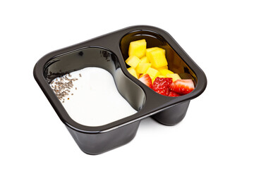 Portion of yogurt dessert with strawberry and mango in a plastic bowl.
