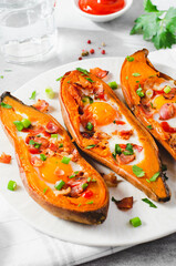 Baked Sweet Potato Stuffed with Egg, Bacon, and Green Onions on Bright Background