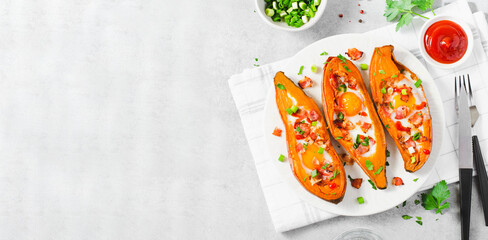 Baked Sweet Potato Stuffed with Egg, Bacon, and Green Onions on Bright Background