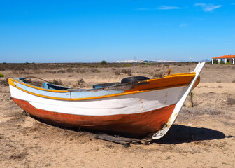 Naklejka na ściany i meble Wooden fisher boat on a beach