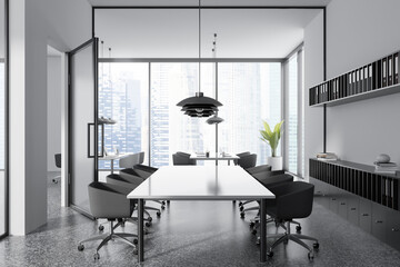 Light office room interior with meeting and coworking space near window