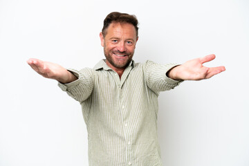 Fototapeta premium Middle age caucasian man isolated on white background presenting and inviting to come with hand