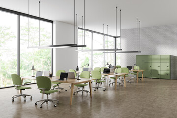 Stylish coworking interior with laptop on desk, shelves and panoramic window