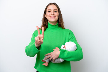 Young caucasian woman with her cute baby isolated on white background smiling and showing victory sign