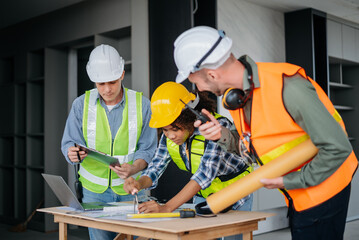 Architect caucasian man working with colleagues mixed race in the construction site. Architecture engineering on big project. Building in construction interior.