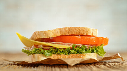 Sandwich with lettuce, tomato, ham and cheese