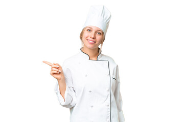 Young chef woman over isolated chroma key background pointing finger to the side
