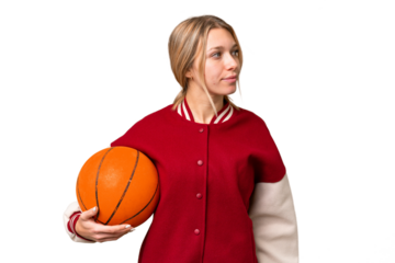 Young hispanic woman playing basketball over isolated white background looking to the side