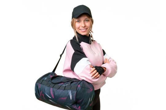 Pretty sport woman with sport bag over isolated chroma key background with arms crossed and looking forward - Powered by Adobe