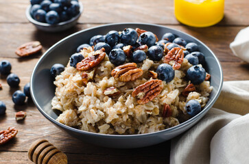 Oatmeal Bowl, Oat Porridge with Blueberry and Pecans in a Bowl on Rustic Background, Healthy Snack or Breakfast