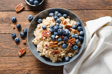 Oatmeal Bowl, Oat Porridge with Blueberry and Pecans in a Bowl on Rustic Background, Healthy Snack or Breakfast