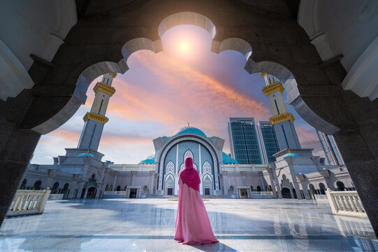 Woman dressed in islamic clothing in     Masjid Wilayah Persekutuan (Federal Territory Mosque), and sunlight in Kuala Lumpur, Malaysia.