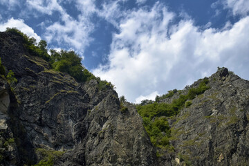 Tranquil scenic view of majestic rocky mountains against cloudy sky. Copy space. Selective focus.