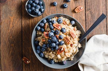 Oatmeal Bowl, Oat Porridge with Blueberry and Pecans in a Bowl on Rustic Background, Healthy Snack or Breakfast